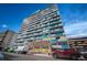 Modern condo building with blue accents and ample parking at 1155 N Ash St # 806, Denver, CO 80220