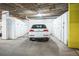 Well-lit garage area with clean, numbered storage units, showcasing a white SUV parked inside at 1155 N Ash St # 806, Denver, CO 80220