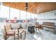 Cozy patio area with marble flooring, wooden ceiling, seating arrangements, and an outdoor fireplace feature at 1155 N Ash St # 806, Denver, CO 80220