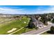 Expansive aerial image showcases a golf course community with beautiful homes and lush landscaping at 3383 Mount Royal Dr # 46, Castle Rock, CO 80104