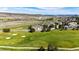 Scenic aerial view of a golf course community with beautiful green fairways and a charming neighborhood at 3383 Mount Royal Dr # 46, Castle Rock, CO 80104