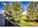Overlooking backyard with beautiful trees and landscaping, captured from a deck with wood railings at 3383 Mount Royal Dr # 46, Castle Rock, CO 80104