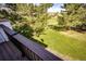 Overlooking backyard with beautiful trees and landscaping, captured from a deck with wood railings at 3383 Mount Royal Dr # 46, Castle Rock, CO 80104