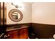 Well-lit half bathroom featuring a decorative mirror and vanity at 3383 Mount Royal Dr # 46, Castle Rock, CO 80104
