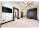A spacious bedroom with a ceiling fan, neutral carpet, and an attached bath at 3383 Mount Royal Dr # 46, Castle Rock, CO 80104