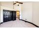 A spacious bedroom with carpet flooring, a ceiling fan, and a closet at 3383 Mount Royal Dr # 46, Castle Rock, CO 80104