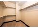 A walk-in closet with built-in shelving and carpeted floors at 3383 Mount Royal Dr # 46, Castle Rock, CO 80104