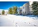 Two-story townhome exterior with snowy landscape and trees at 3383 Mount Royal Dr # 46, Castle Rock, CO 80104