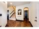Entryway with hardwood floors, staircase, decorative archway, and stylish black doors and trim at 3383 Mount Royal Dr # 46, Castle Rock, CO 80104