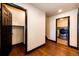 Bright hallway featuring hardwood floors, white walls, and a laundry room at 3383 Mount Royal Dr # 46, Castle Rock, CO 80104