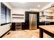 Gourmet kitchen features a stainless steel refrigerator, wine fridge, stone tile floors, and dark cabinets at 3383 Mount Royal Dr # 46, Castle Rock, CO 80104