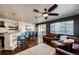 Living room with hardwood floors, fireplace, and kitchen bar at 3383 Mount Royal Dr # 46, Castle Rock, CO 80104