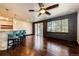 A sun-filled living room with hardwood floors, bar seating, and sliding glass doors at 3383 Mount Royal Dr # 46, Castle Rock, CO 80104