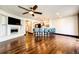 Bright living room featuring a fireplace, hardwood floors, and open-concept kitchen with bar seating at 3383 Mount Royal Dr # 46, Castle Rock, CO 80104