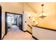 Upstairs hallway with chandelier and access to bedrooms at 3383 Mount Royal Dr # 46, Castle Rock, CO 80104