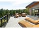 Relaxing backyard deck boasting mountain views, lounge chairs, and modern design at 29822 Troutdale Scenic Dr, Evergreen, CO 80439
