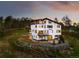 Back exterior featuring multi-level patios offering panoramic views of the surrounding landscape at 29822 Troutdale Scenic Dr, Evergreen, CO 80439