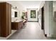 Modern bathroom with double vanities, decorative wall, and a glass-enclosed shower at 29822 Troutdale Scenic Dr, Evergreen, CO 80439