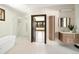 Modern bathroom with a soaking tub, a separate shower, and double sinks at 29822 Troutdale Scenic Dr, Evergreen, CO 80439
