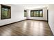 Spacious bedroom with large windows offering picturesque views and light hardwood flooring at 29822 Troutdale Scenic Dr, Evergreen, CO 80439