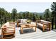 Relax on the outdoor deck with mountain views, featuring modern furniture, perfect for entertaining or unwinding in nature at 29822 Troutdale Scenic Dr, Evergreen, CO 80439