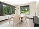 Bright dining room features large windows offering scenic views of the wooded surroundings, perfect for enjoying meals at 29822 Troutdale Scenic Dr, Evergreen, CO 80439