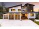 Striking modern home showcasing a three-car garage and unique architectural details at 29822 Troutdale Scenic Dr, Evergreen, CO 80439