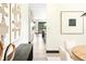 Bright, open hallway that leads to a dining room, with decorative art pieces that adds a touch of elegance at 29822 Troutdale Scenic Dr, Evergreen, CO 80439
