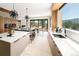 Modern kitchen with an island, stone countertops, wood cabinets, and a beautiful view at 29822 Troutdale Scenic Dr, Evergreen, CO 80439