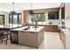 Modern kitchen featuring wooden cabinets, white countertops, a large island, and modern lighting at 29822 Troutdale Scenic Dr, Evergreen, CO 80439