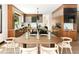 Dining area and modern kitchen with stainless steel appliances, wooden cabinets, and island at 29822 Troutdale Scenic Dr, Evergreen, CO 80439