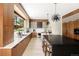 Bright modern kitchen featuring wooden cabinets, white countertops, and a large window at 29822 Troutdale Scenic Dr, Evergreen, CO 80439
