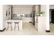 Modern kitchen featuring updated appliances, island with bar stools, and marble countertops at 29822 Troutdale Scenic Dr, Evergreen, CO 80439