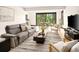 Open-concept living room with modern furniture and view of outdoor patio at 29822 Troutdale Scenic Dr, Evergreen, CO 80439