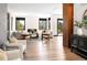Bright living room with modern furniture, hardwood floors, and large windows with a view at 29822 Troutdale Scenic Dr, Evergreen, CO 80439