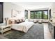 Serene primary bedroom with natural light, showcasing scenic outdoor views and comfortable seating area at 29822 Troutdale Scenic Dr, Evergreen, CO 80439