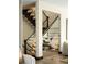 Modern staircase with glass railings and wood steps, blending contemporary design with natural elements at 29822 Troutdale Scenic Dr, Evergreen, CO 80439