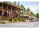 Street view features rustic storefronts, quaint balconies, American flags, and vintage charm at 29822 Troutdale Scenic Dr, Evergreen, CO 80439