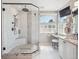 Bathroom showcases a walk-in shower with glass door, granite counters, and vanity seating area at 9531 Desert Willow Way, Highlands Ranch, CO 80129