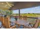 Covered deck with patio dining set provides an outdoor living space and scenic views at 9531 Desert Willow Way, Highlands Ranch, CO 80129
