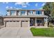 Charming two-story home featuring a brick and tan exterior, a two-car garage, and a well-manicured front lawn at 9531 Desert Willow Way, Highlands Ranch, CO 80129