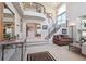 Elegant foyer with a curved staircase, wrought iron railings, and high ceilings, creating a grand entrance at 9531 Desert Willow Way, Highlands Ranch, CO 80129