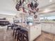 Bright kitchen with island, granite countertops, tile flooring and unique pot rack at 9531 Desert Willow Way, Highlands Ranch, CO 80129