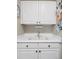 Clean and bright laundry room with white cabinets, sink, and ample counter space at 9531 Desert Willow Way, Highlands Ranch, CO 80129