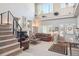 Bright living room featuring a fireplace, high ceilings, and ample natural light, creating an open and airy space at 9531 Desert Willow Way, Highlands Ranch, CO 80129