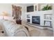 Cozy living room with fireplace, built-in shelving, comfortable seating, and decorative accents at 9531 Desert Willow Way, Highlands Ranch, CO 80129