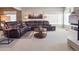 Spacious living room with a leather sofa and a neutral decor at 9531 Desert Willow Way, Highlands Ranch, CO 80129