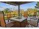 Inviting outdoor patio with comfortable seating around a tiled fire pit at 9531 Desert Willow Way, Highlands Ranch, CO 80129