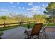 Charming outdoor patio featuring cozy seating with a scenic green landscape backdrop at 9531 Desert Willow Way, Highlands Ranch, CO 80129