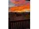 Backyard sunset view with vibrant orange and pink hues painting the sky over distant mountains at 9531 Desert Willow Way, Highlands Ranch, CO 80129